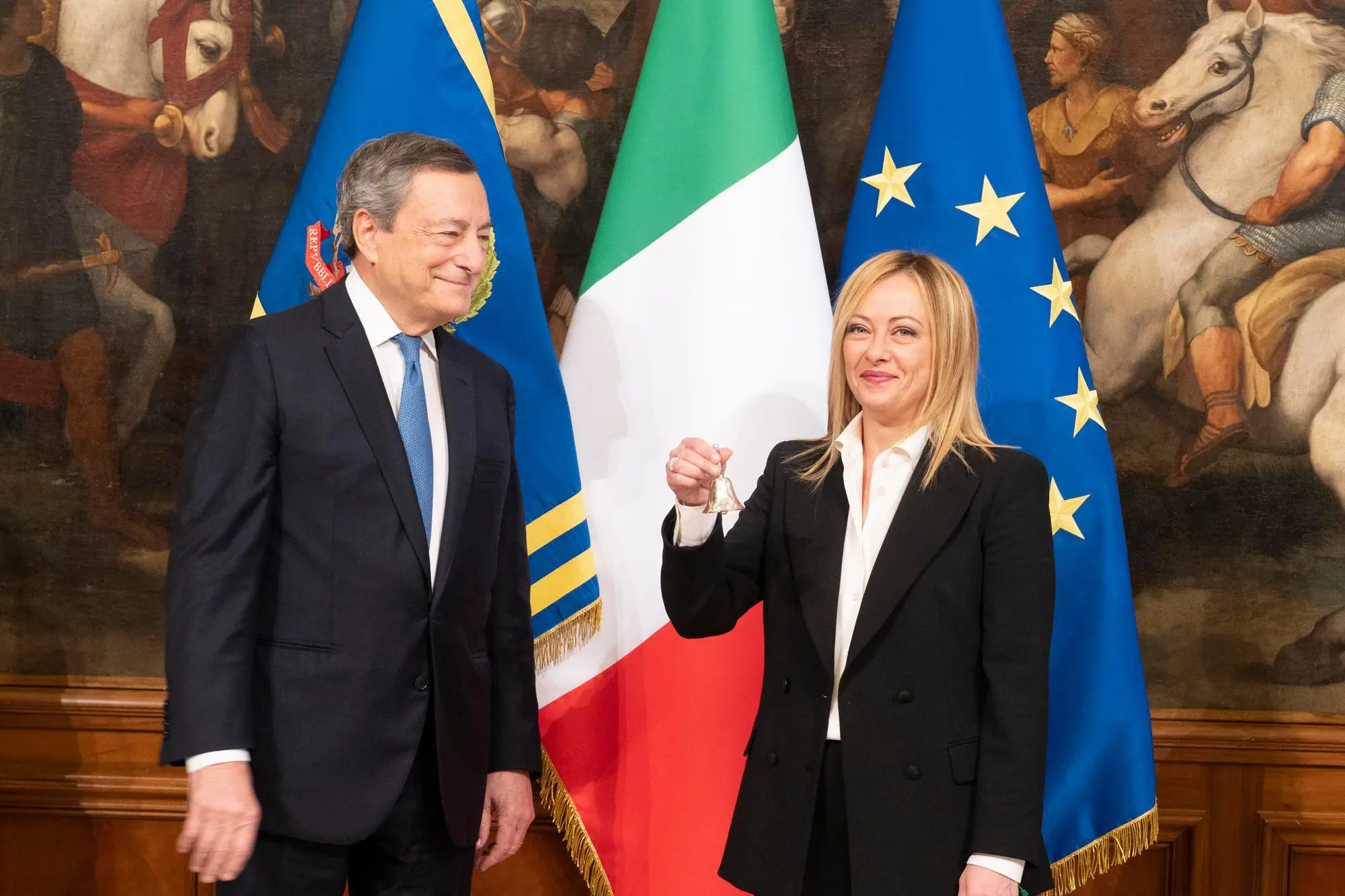 This handout picture, provided by Chigi Palace Press Office, shows Italy's outgoing Prime Minister Mario Draghi (L) hands over the bell used by the cabinet President to manage cabinet debates to Prime Minister, Giorgia Meloni (R), during the handover ceremony at Chigi Palace in Rome, Italy, 23 October 2022. Newly elected Prime Minister, Giorgia Meloni, and her cabinet were sworn in on 22 October. NPK ANSA / Filippo Attili - Chigi Palace Press Office handout +++ ANSA PROVIDES ACCESS TO THIS HANDOUT PHOTO TO BE USED SOLELY TO ILLUSTRATE NEWS REPORTING OR COMMENTARY ON THE FACTS OR EVENTS DEPICTED IN THIS IMAGE; NO ARCHIVING; NO LICENSING +++