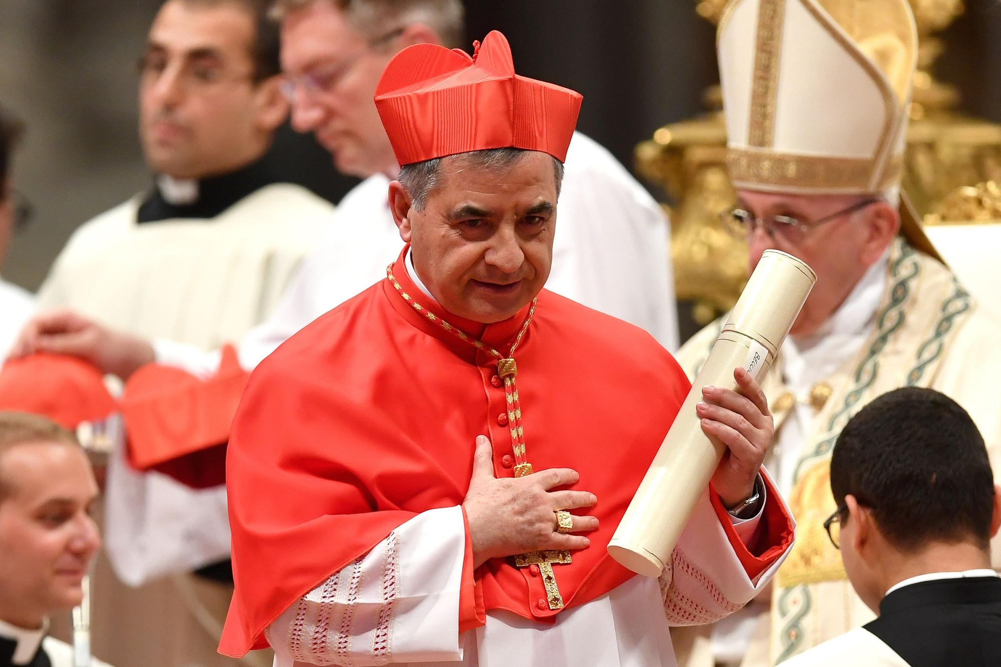 Italian Giovanni Angelo Becciu substitute for General Affairs of the Secretariat of State and special delegate to the Sovereign Military Order of Malta leaves after kneeling before Pope Francis to pledge allegiance and become a cardinal during a consistory for the creation of fourteen new cardinals on June 28, 2018 at St Peter's basilica in Vatican. / AFP PHOTO / Andreas SOLARO