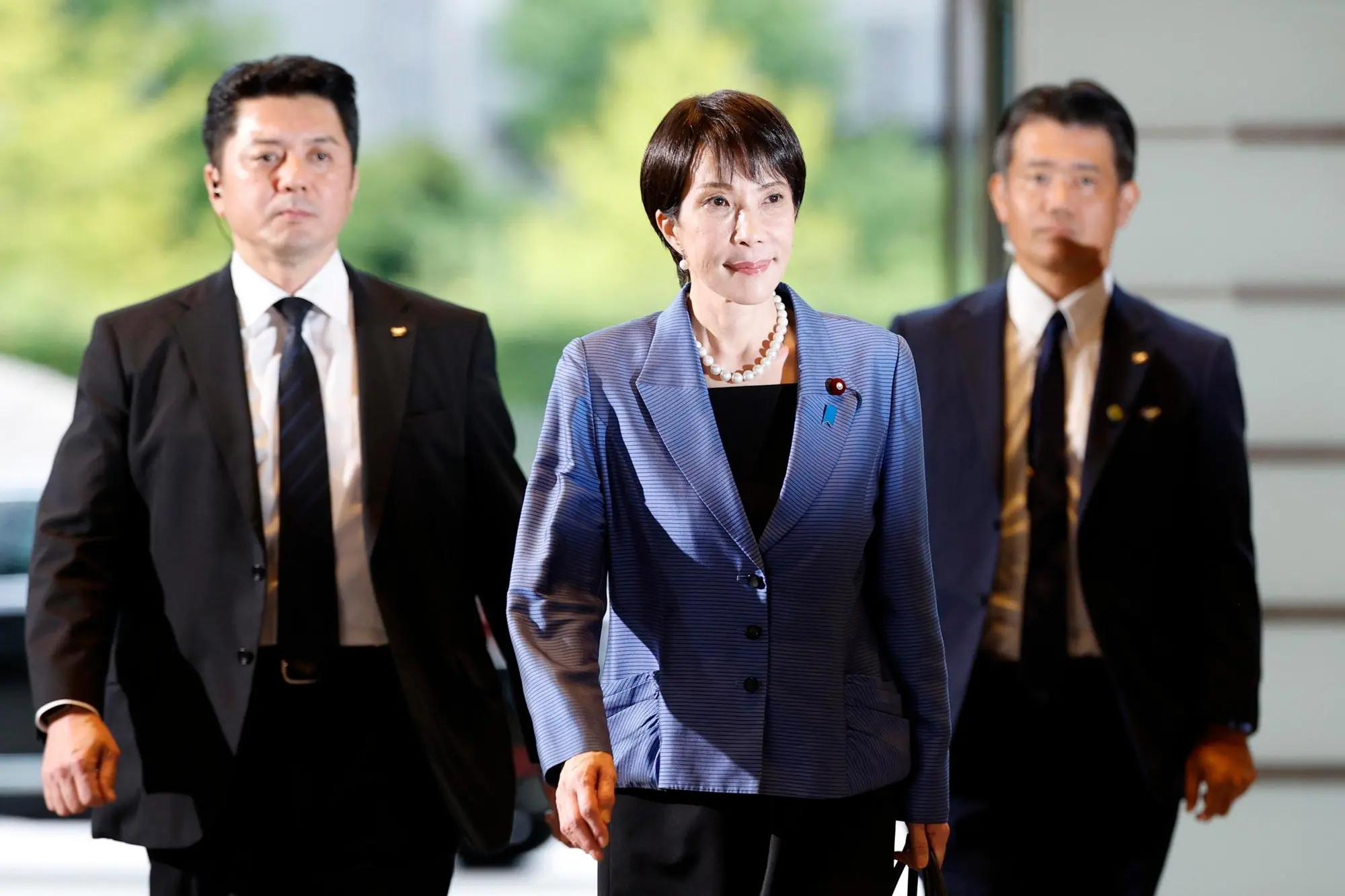epa12469104 Sanae Takaichi (C) arrives at the Prime Minister's official residence after being elected as the new Prime Minister in Tokyo, Japan, 21 October 2025. Japan's ruling Liberal Democratic Party President Sanae Takaichi became Japan's first female prime minister. EPA/FRANCK ROBICHON