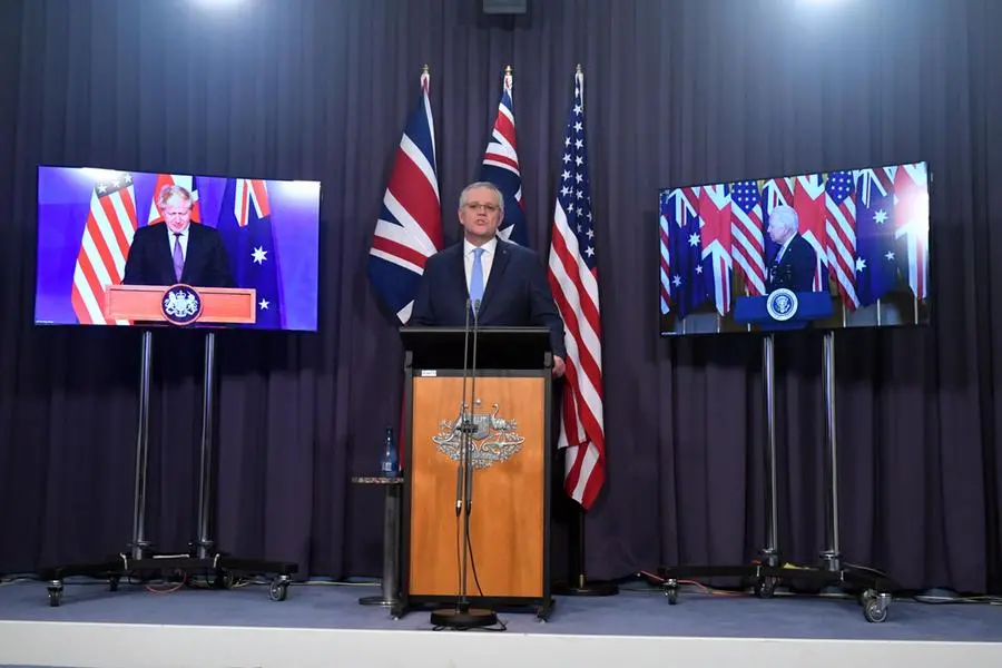 Il premier australiano Scott Morrison in videoconferenza con Boris Johnson e Joe Biden per presentare l'accordo Aukus (Ansa)