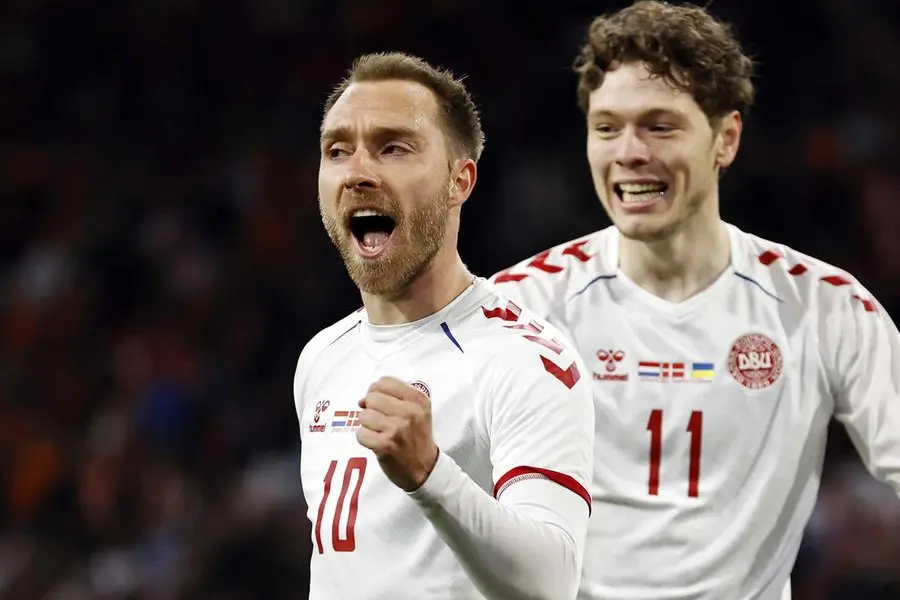 epaselect epaselect epa09852044 Christian Eriksen (L) of Denmark celebrates with teammate Andreas Skov Olsen after scoring his team's second goal during the International friendly soccer match between The Netherlands and Denmark at the Johan Cruijff ArenA in Amsterdam, Netherlands, 26 March 2022. EPA/MAURICE VAN STEEN