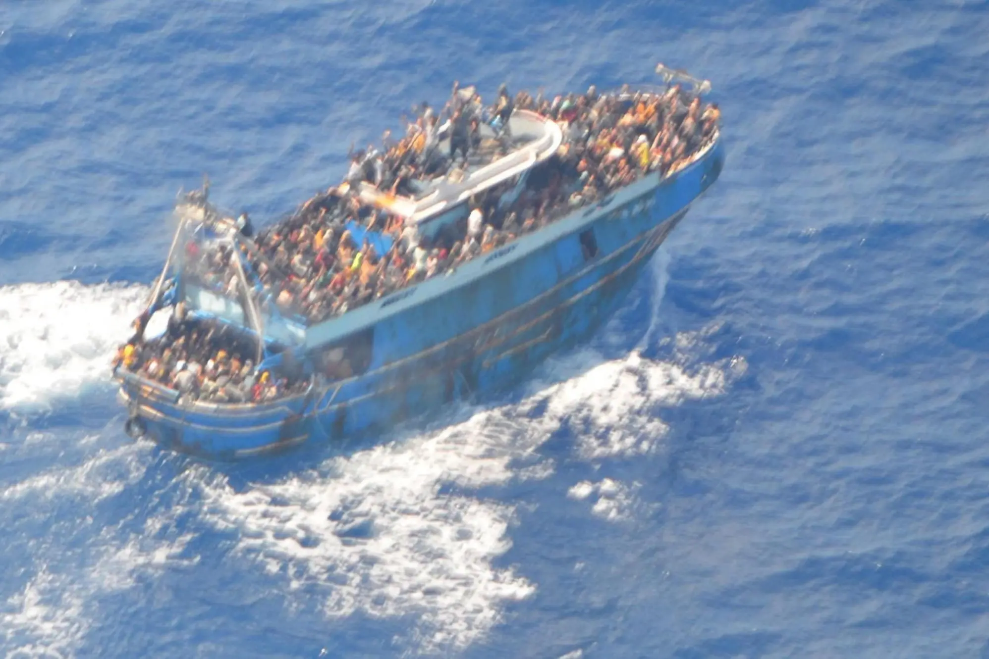 epa10691107 A handout photo made available by the Hellenic Coast Guard on 14 June 2023 shows a fishing vessel carrying a large number of migrants sailing in international waters, near western Peloponnese. 104 people were rescued by the Coast Guard during the search-and-rescue operation after a fishing boat, carrying an unknown number of migrants, capsized in international waters on 14 June, 47 nautical miles southwest of the Peloponnese coast and the town of Pylos. The death toll of the shipwreck rose to at least 79, authorities said. EPA/HELLENIC COAST GUARD / HANDOUT -- BEST QUALITY AVAILABLE -- HANDOUT EDITORIAL USE ONLY/NO SALES