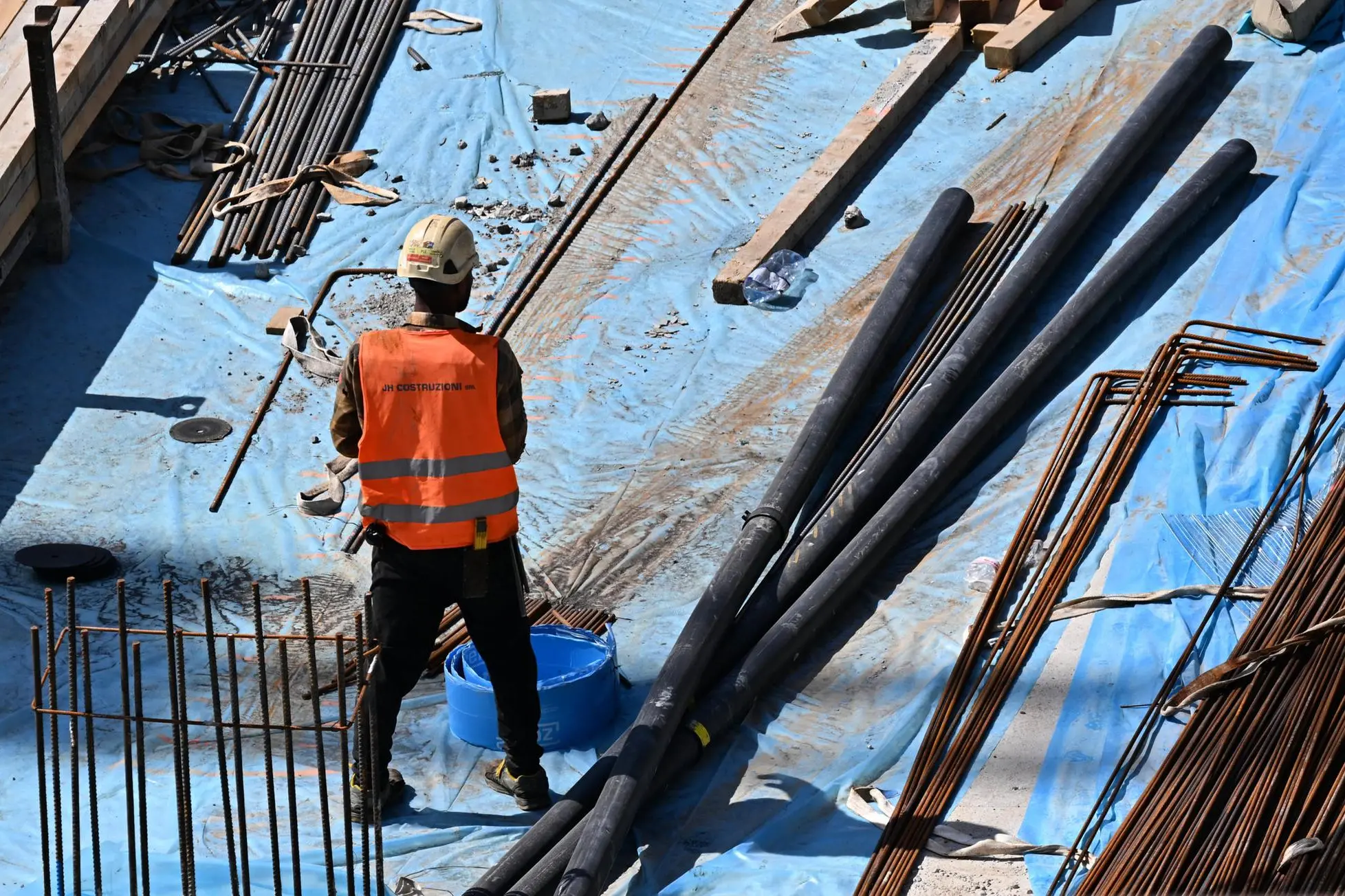 Un operaio del settore edile al lavoro sotto il sole in un cantiere (Foto simbolo)