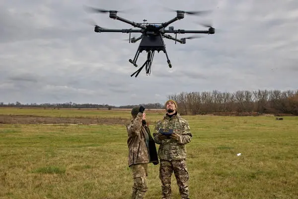 epa10286425 Ukrainian members of the volunteer unit Khartiia attends a training to learn how to operate drones, in a field near Kharkiv, Ukraine, 04 November 2022. Russian troops entered Ukrainian territory on 24 February, starting a conflict that has provoked destruction and a humanitarian crisis. EPA/SERGIY KOZLOV