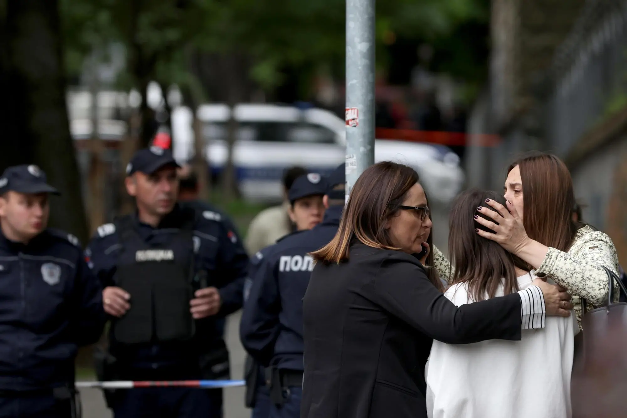 epa10605740 Teachers console students near the Vladislav Ribnikar elementary school in Belgrade, Serbia, 03 May 2023. A teenage suspect opened fire causing one fatality and multiple injuries according to Serbia's Interior ministry. EPA/ANDREJ CUKIC