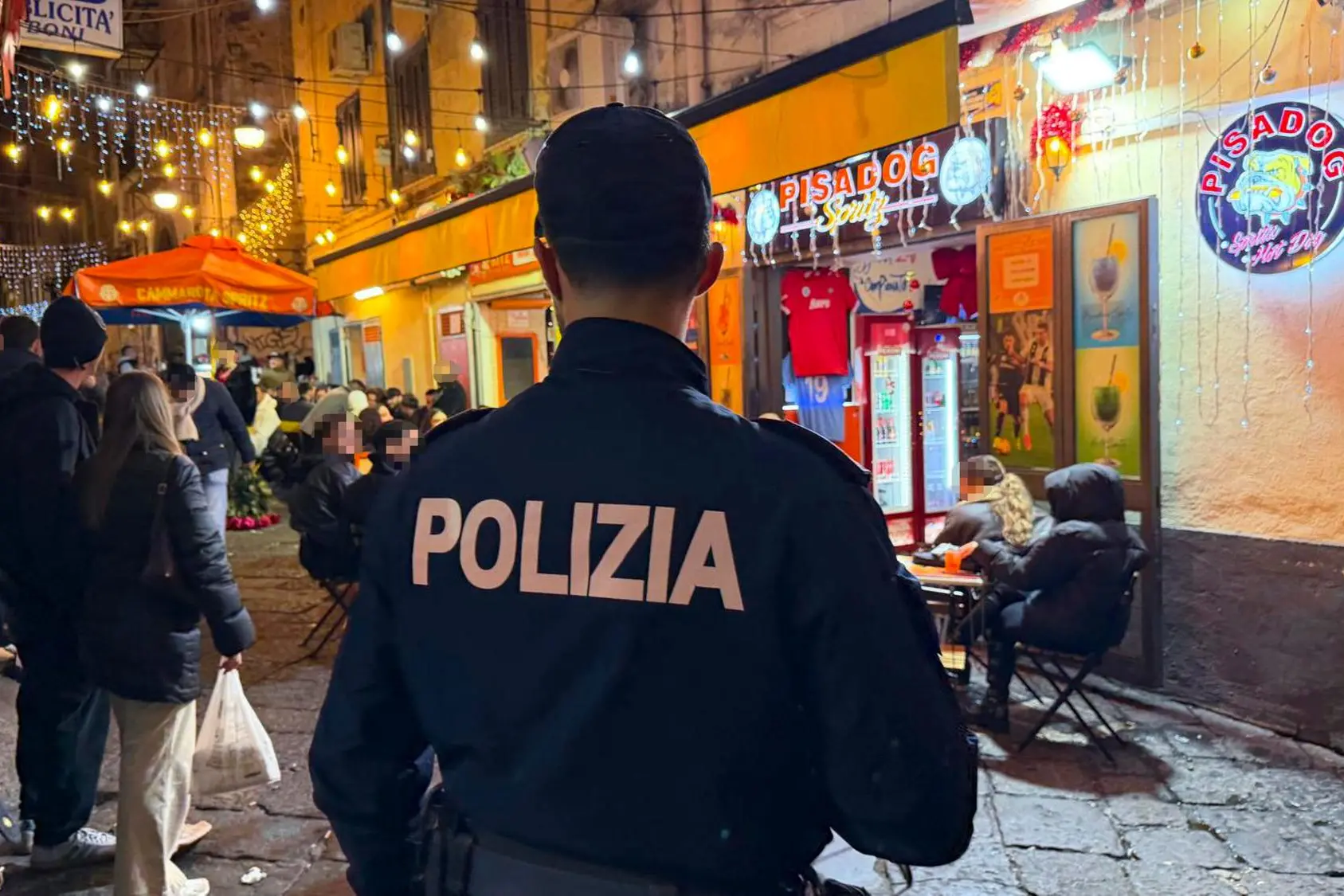 La Polizia davanti al locale dei Pisacane (Ansa)
