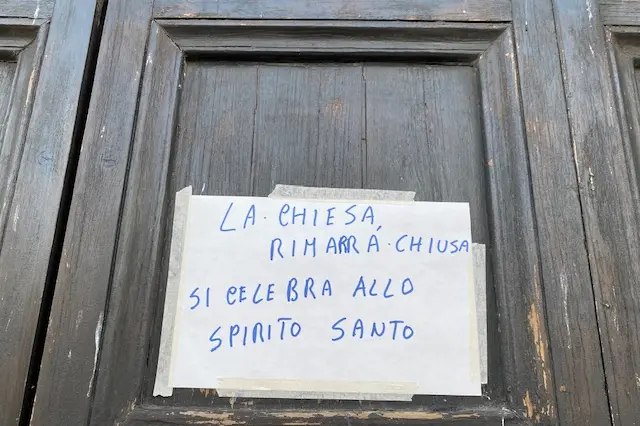 Il cartello comparso sul portone della chiesa di Santa Maria (foto di Sara Pinna)