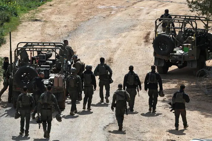 epa12825194 Israeli soldiers gather at an undisclosed position along the Israel-Lebanon border in northern Israel, 16 March 2026. The Israeli military stated it is conducting strikes across Lebanon targeting Hezbollah infrastructure and personnel. EPA/ATEF SAFADI