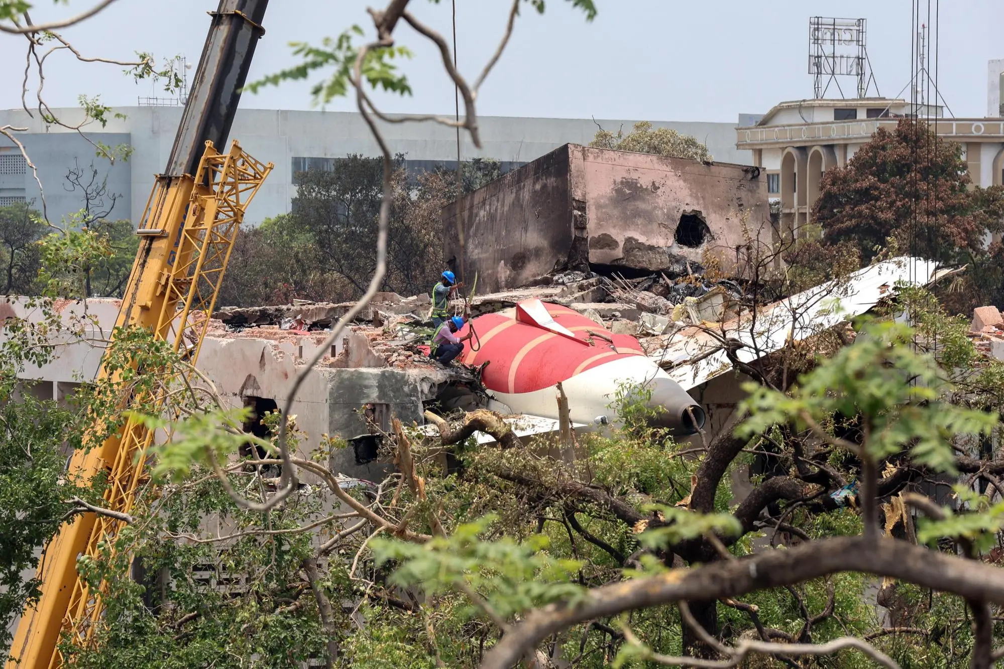 epa12174658 Officials inspect the remains of the Air India passenger plane at the crash site near Sardar Vallabhbhai Patel International Airport in Ahmedabad, Gujarat state, western India, 14 June 2025. Air India flight AI171, bound for London carrying 242 passengers and crew members on board a Boeing 787-8 aircraft, crashed minutes after take-off in the Meghaninagar area of Ahmedabad on 12 June. EPA/RAJAT GUPTA