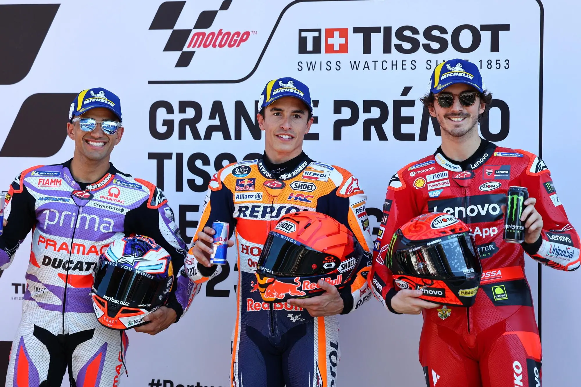 epa10542446 Spanish MotoGP rider Marc Marquez of Repsol Honda Team (C) celebrates taking pole position with second placed Italian MotoGP rider Francesco Bagnaia (R) of Ducati Lenovo Team and third placed Spanish MotoGP rider Jorge Martin (L) of Prima Pramac Racing after the qualifying for the Motorcycling Grand Prix of Portugal at Algarve International race track, Portimao, Portugal, 25 March 2023. The Motorcycling Grand Prix of Portugal will take place on 26 March 2023. EPA/NUNO VEIGA