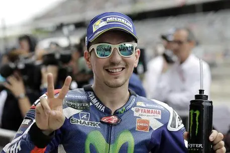 Jorge Lorenzo, of Spain, poses for photos after he finished second in qualifying for the Grand Prix of the Americas MotoGP motorcycle race, Saturday, April 9, 2016, in Austin, Texas. (ANSA/AP Photo/Eric Gay) [CopyrightNotice: Copyright 2016 The Associated Press. All rights reserved. This material may not be published, broadcast, rewritten or redistributed without permission.]