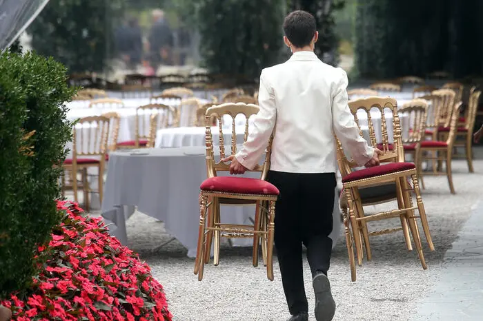 A waiter works for the start of the Ambrosetti Forum “Intelligence on the world, Europe, and Italy” in Villa d’Este Cernobbio on Como lake, 3 September 2021. ANSA / MATTEO BAZZI