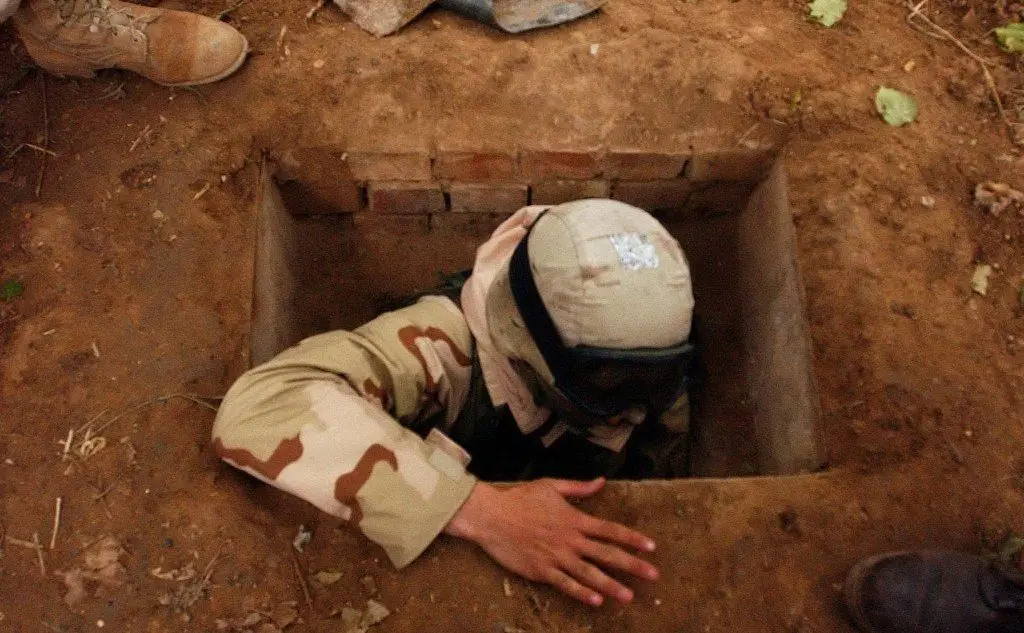 Un soldato si cala nel bunker dell'ex rais