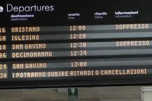 Il tabellone degli orari della stazione di Cagliari avvisa della soppressione di alcuni treni