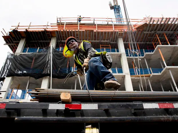 epa09332110 Construction workers build on a construction site in Washington, DC, USA, 08 July 2021. With the economy strengthening during the reopening from the COVID-19 pandemic, there is a shortage of construction workers in the United States. The construction industry was still down 238,000 workers from pre-pandemic levels in June 2021, according to the US Labor Department. In order to meet expected demand, construction companies will need to hire 430,000 workers this year and one million more over the next two years, according to Associated Builders and Contractors. EPA/MICHAEL REYNOLDS