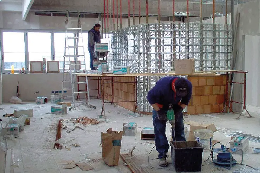 Due operai al lavoro in un cantiere