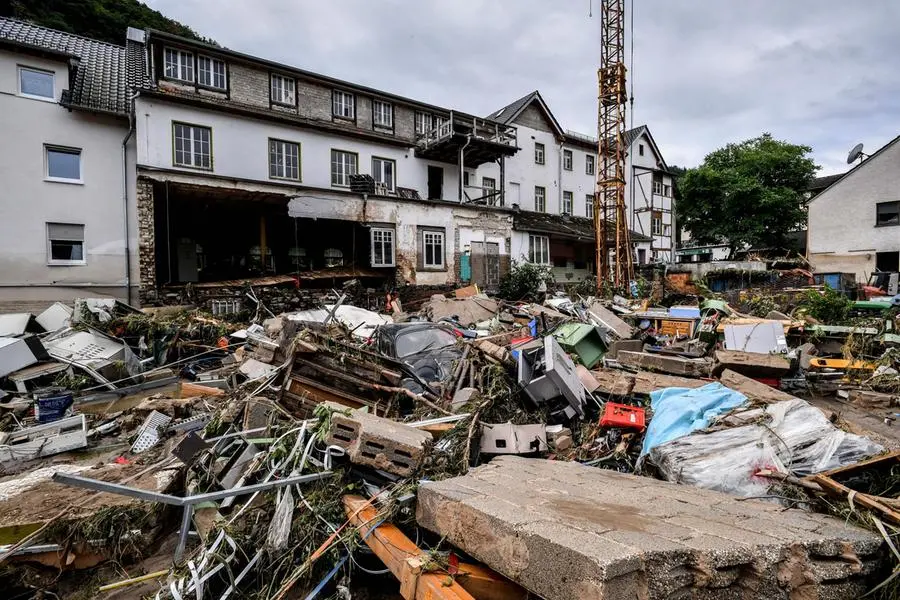 epa09345888 Debris of houses and cars after flooding in Schuld, Germany, 15 July 2021. Large parts of Western Germany were hit by heavy, continuous rain in the night to 15 July, resulting in local flash floods that destroyed buildings and swept away cars. EPA/SASCHA STEINBACH