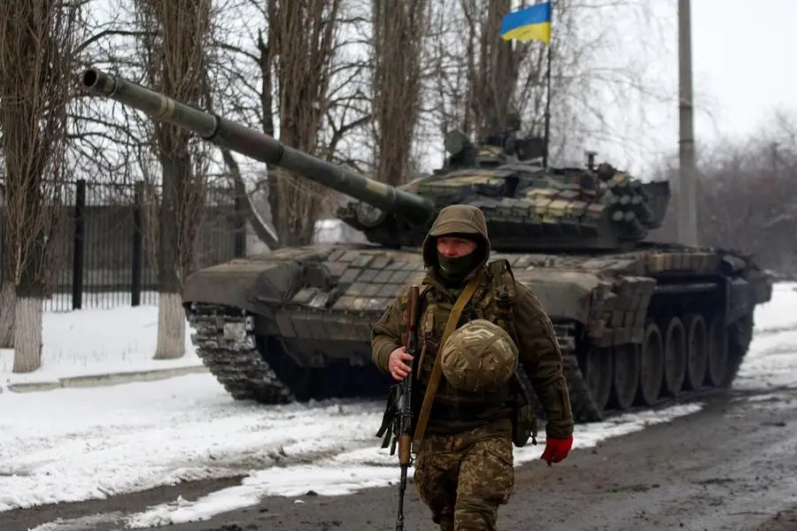 Serviceman of the Ukrainian Military Forces goes on a position in the Lugansk region on March 11, 2022. (Photo by Anatolii Stepanov / AFP)