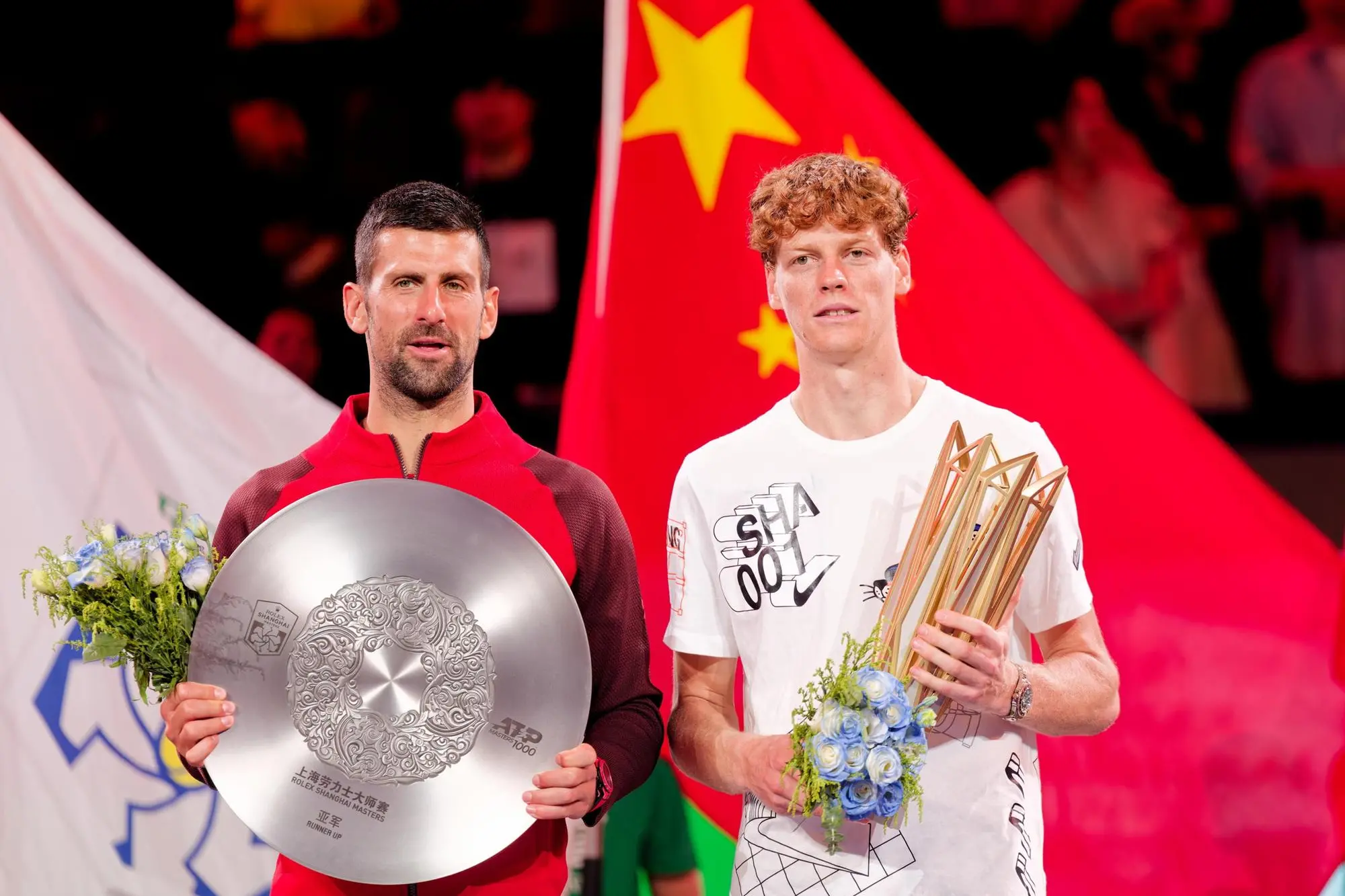 epa11657020 Jannik Sinner (R) of Italy poses with his trophy after winning his Men's Singles Final match against Novak Djokovic (L) of Serbia at the Shanghai Masters tennis tournament in Shanghai, China, 13 October 2024. EPA/ALEX PLAVEVSKI