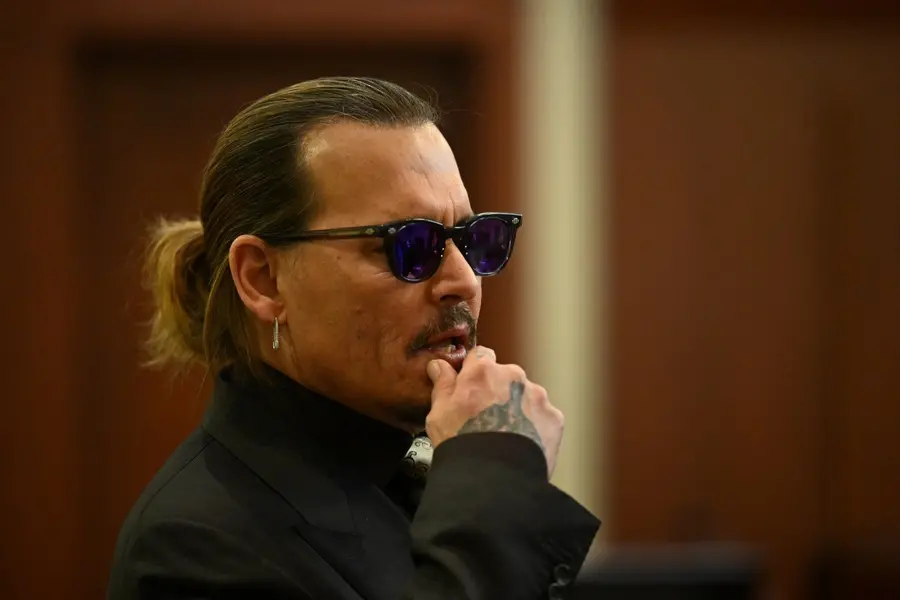 epa09898085 US actor Johnny Depp looks on during his defamation trial in the Fairfax County Circuit Courthouse in Fairfax, Virginia, USA, 19 April 2022. Johnny Depp's 50 million US dollars defamation lawsuit against Amber Heard that started on 10 April is expected to last five or six weeks. EPA/JIM WATSON / POOL
